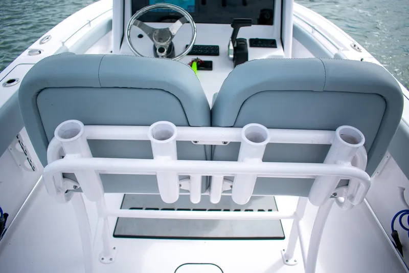 Slide: The Image of 2026 Sportsman Open 212 Center Console boat interior with dual seats and rod holders. - 17
