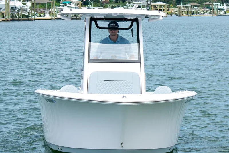 Slide: The Image of 2026 Sportsman Open 212 Center Console boat on water, front view. - 2
