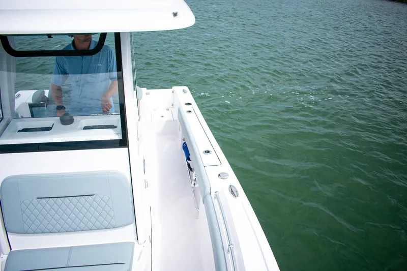 Slide: The Image of 2026 Sportsman Open 212 Center Console boat on calm water, featuring sleek design and modern amenities. - 12