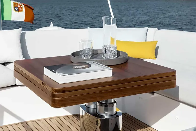 Slide: The Image of Manufacturer Provided Image: Luxurious Azimut Fly 53 yacht deck with wooden table, drinks, and cushions, 2025 model. - 5