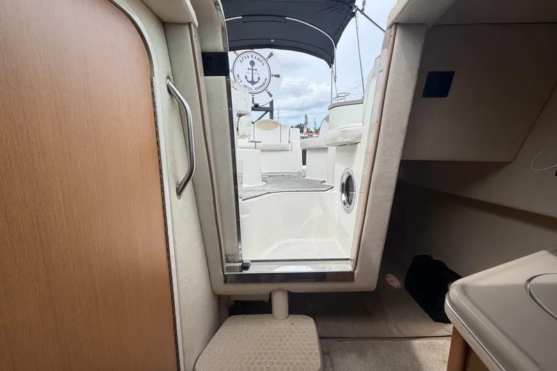 Slide: The Image of Interior view of 2009 Sea Ray 240 Sundancer cabin with open door to deck. - 87