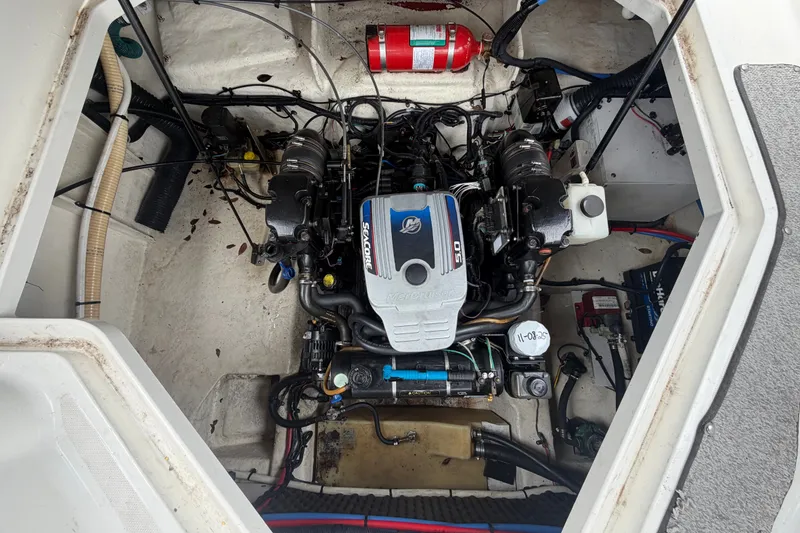 Slide: The Image of Engine compartment of a 2009 Sea Ray 240 Sundancer boat, featuring a MerCruiser engine. - 95