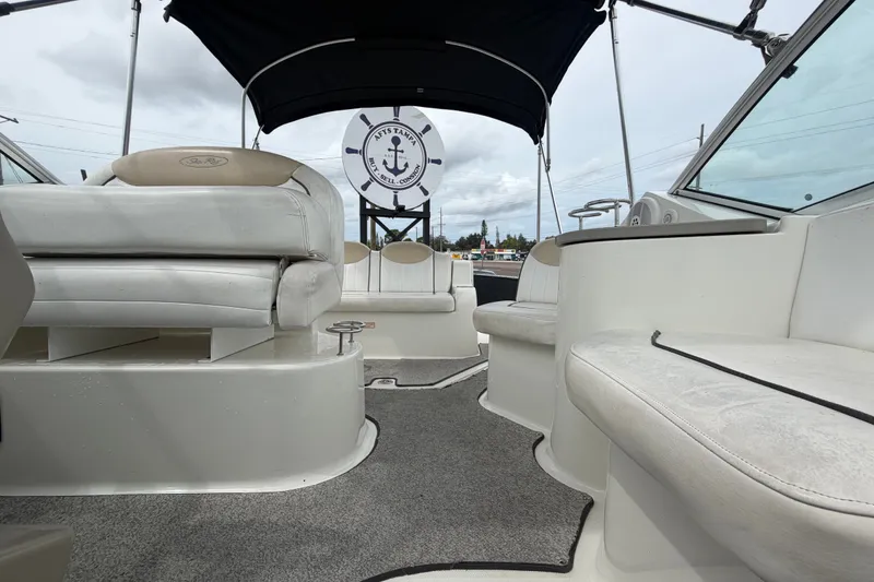 Slide: The Image of 2009 Sea Ray 240 Sundancer boat interior with white seating and canopy. - 88