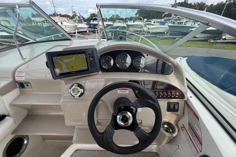 Slide: The Image of Cockpit view of 2009 Sea Ray 240 Sundancer with navigation system and steering wheel. - 13