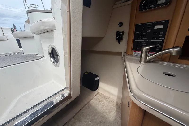 Slide: The Image of 2009 Sea Ray 240 Sundancer cabin interior with sink and control panel. - 83