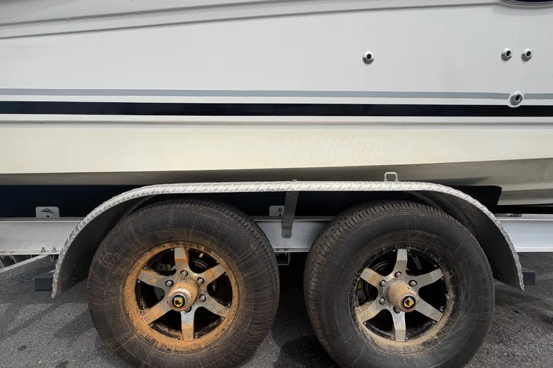 Slide: The Image of Trailer wheels of a 2009 Sea Ray 240 Sundancer boat, showing rust and wear. - 105