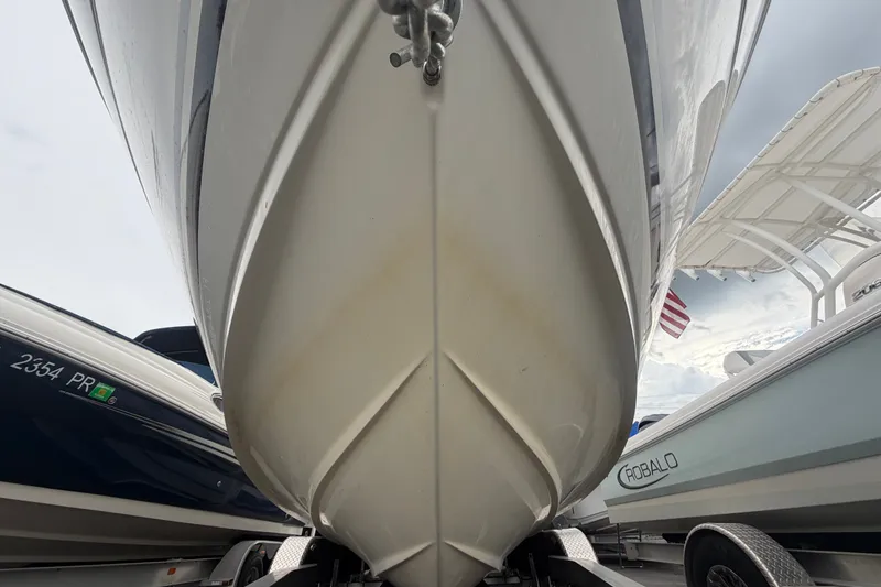 Slide: The Image of 2009 Sea Ray 240 Sundancer boat hull on trailer, flanked by other boats. - 8