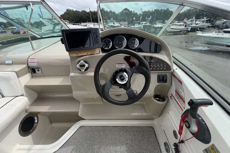Slide: The Image of Steering console of 2009 Sea Ray 240 Sundancer boat with gauges and navigation equipment. - 32