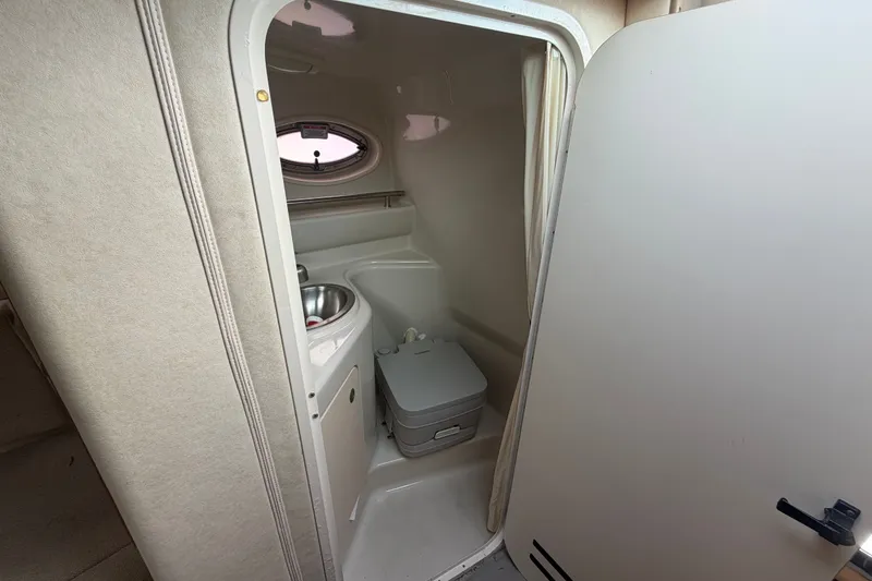 Slide: The Image of Interior of 2009 Sea Ray 240 Sundancer boat bathroom with sink and toilet. - 22