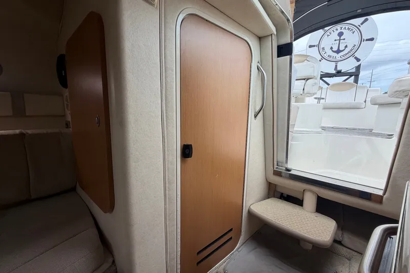 Slide: The Image of Interior view of 2009 Sea Ray 240 Sundancer cabin with seating and door. - 78