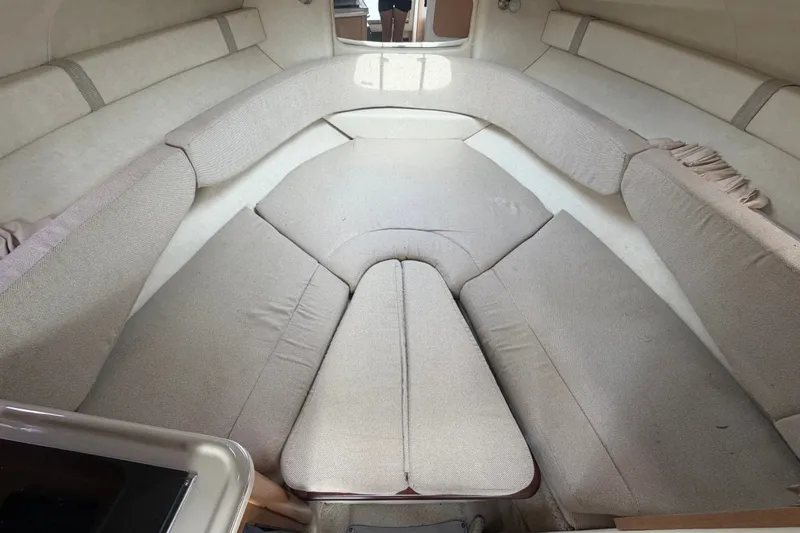Slide: The Image of Interior cabin of 2009 Sea Ray 240 Sundancer with beige upholstery and seating area. - 24