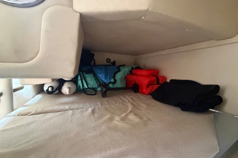Slide: The Image of Interior storage area of a 2009 Sea Ray 240 Sundancer boat with life jackets. - 86