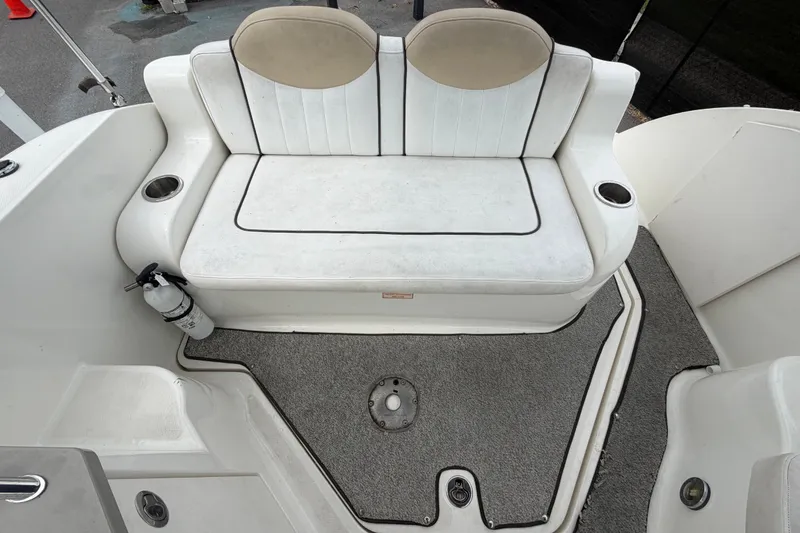 Slide: The Image of 2009 Sea Ray 240 Sundancer boat interior with white seating and carpeted floor. - 91