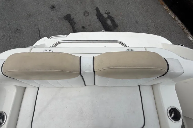 Slide: The Image of Rear seating area of a 2009 Sea Ray 240 Sundancer boat, featuring beige cushions. - 97