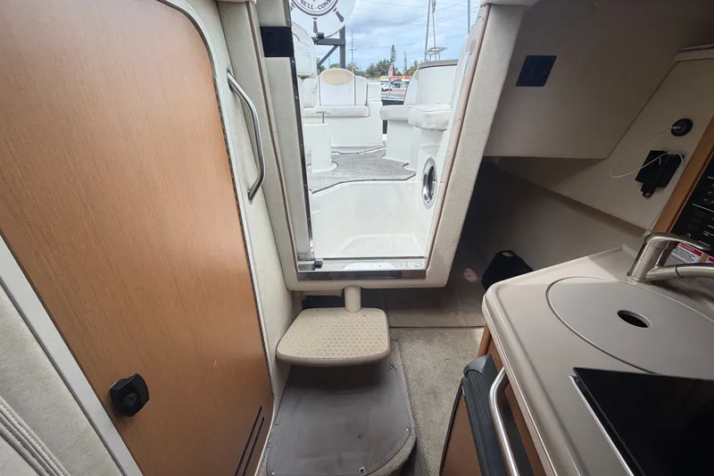 Slide: The Image of Interior view of 2009 Sea Ray 240 Sundancer cabin with kitchenette and exit. - 82