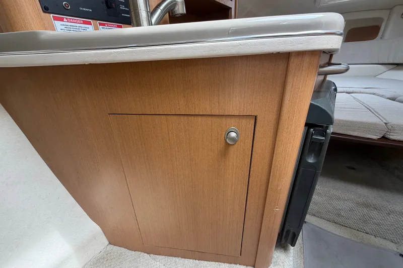 Slide: The Image of Interior cabin of 2009 Sea Ray 240 Sundancer with wooden cabinetry and sink. - 59