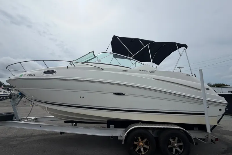 Slide: The Image of 2009 Sea Ray 240 Sundancer boat on trailer, side view with canopy. - 10