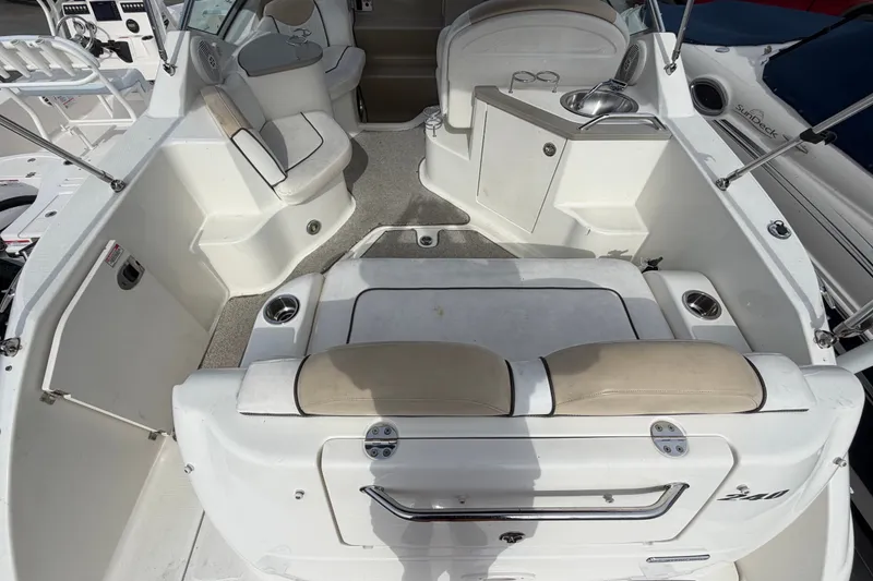Slide: The Image of 2009 Sea Ray 240 Sundancer boat interior with seating and helm area. - 9