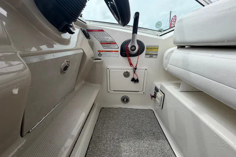 Slide: The Image of Interior view of a 2009 Sea Ray 240 Sundancer boat cockpit with steering controls. - 33