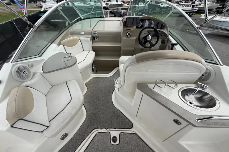 Slide: The Image of Interior of a 2009 Sea Ray 240 Sundancer boat with seating and helm. - 20