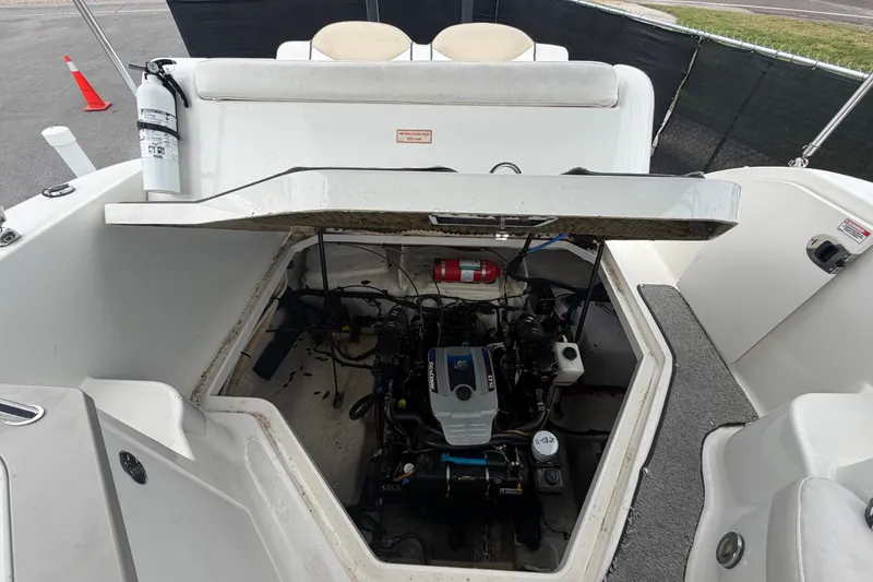 Slide: The Image of Engine compartment of a 2009 Sea Ray 240 Sundancer boat, featuring a visible fire extinguisher. - 94