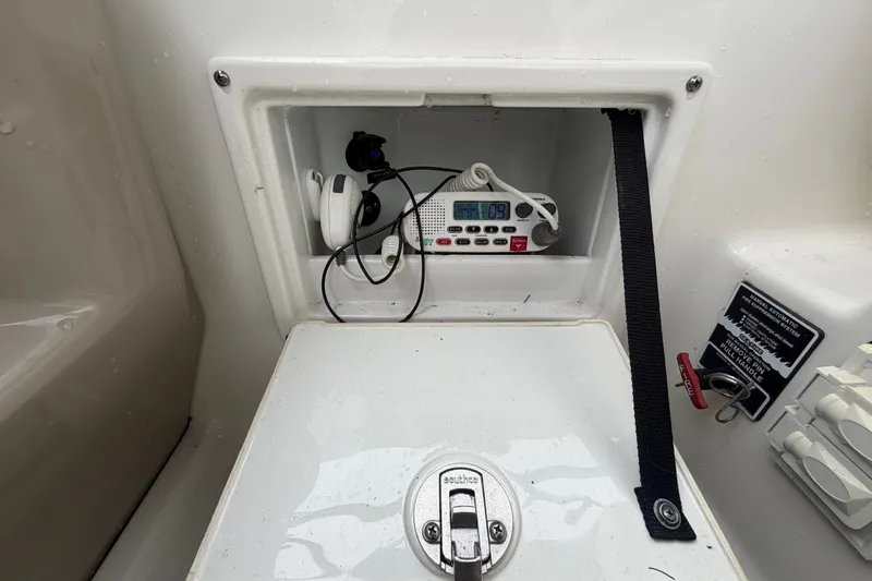 Slide: The Image of Storage compartment on a 2009 Sea Ray 240 Sundancer boat with radio equipment. - 37
