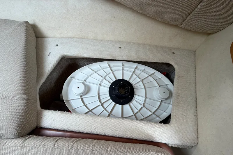 Slide: The Image of Storage compartment in 2009 Sea Ray 240 Sundancer boat interior, showing a white circular component. - 72