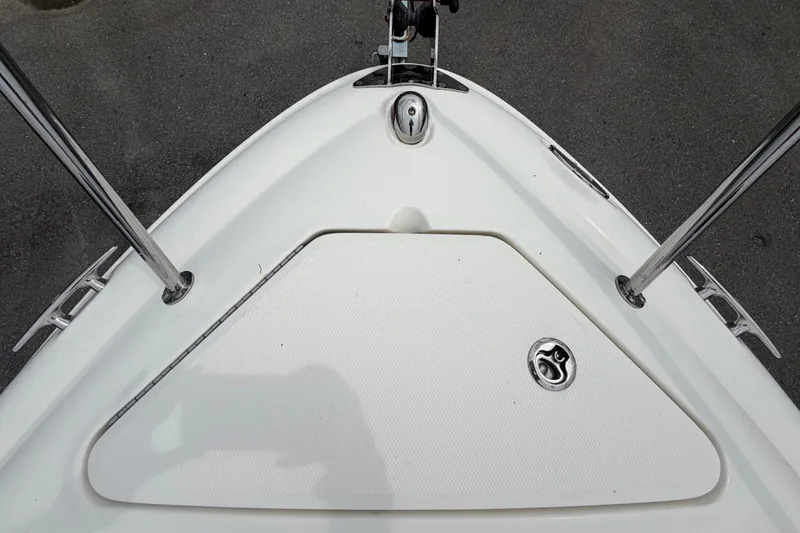 Slide: The Image of Bow view of the Sea Ray 240 Sundancer with anchor windlass and stainless steel railing. - 47
