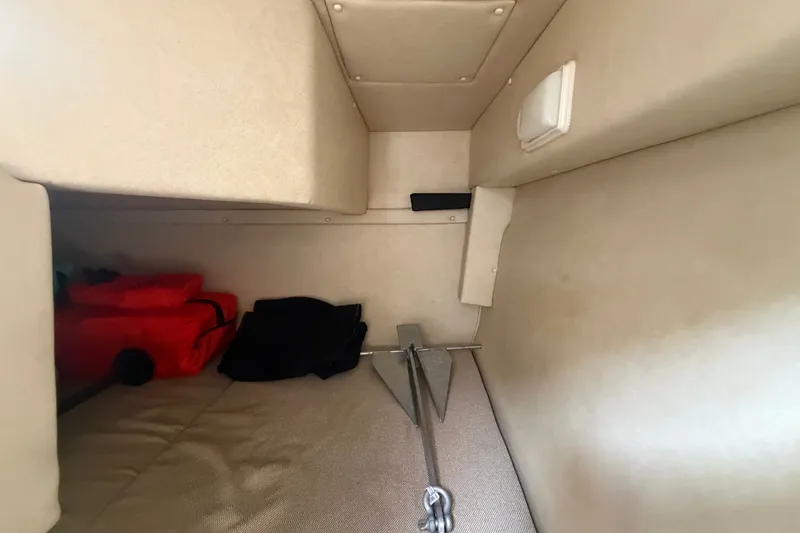 Slide: The Image of Interior cabin of 2009 Sea Ray 240 Sundancer with storage items and anchor. - 85