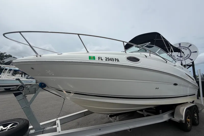 Slide: The Image of 2009 Sea Ray 240 Sundancer boat on trailer, side view, overcast sky. - 11
