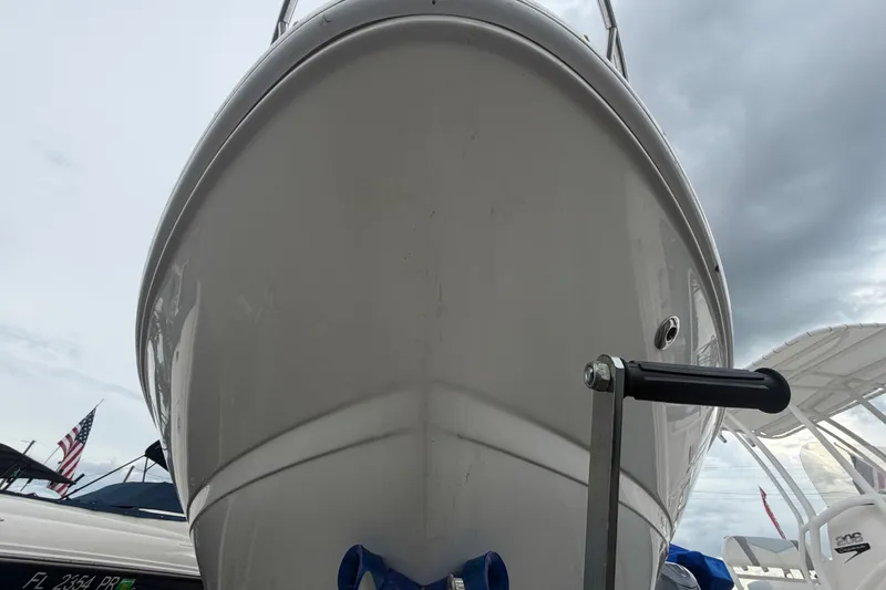 Slide: The Image of 2009 Sea Ray 240 Sundancer boat bow view at marina under cloudy sky. - 7
