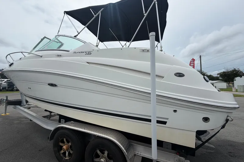 Slide: The Image of 2009 Sea Ray 240 Sundancer boat on trailer with black canopy, side view. - 9