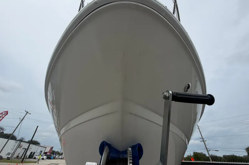 Slide: The Image of 2009 Sea Ray 240 Sundancer boat front view with winch handle, overcast sky. - 12