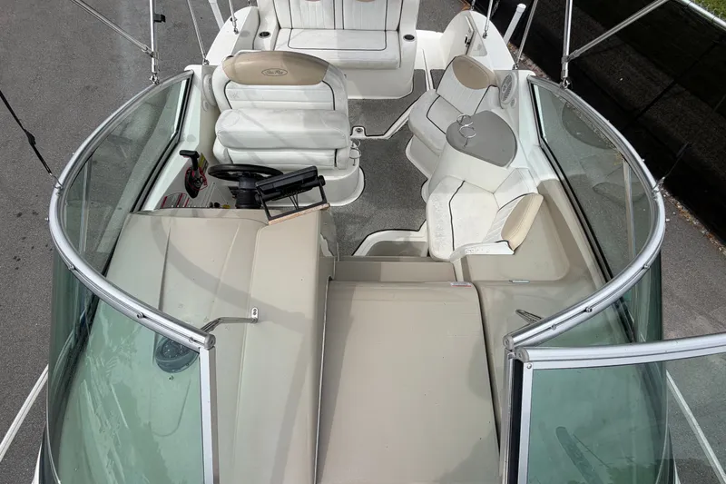 Slide: The Image of 2009 Sea Ray 240 Sundancer boat interior with seating and steering wheel. - 52