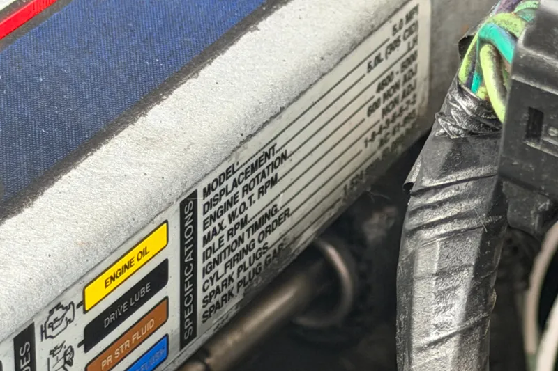 Slide: The Image of Close-up of engine specifications label on a 2009 Sea Ray 240 Sundancer boat. - 101