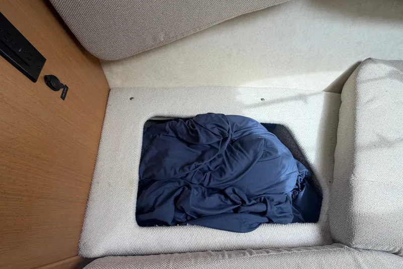 Slide: The Image of Storage compartment in 2009 Sea Ray 240 Sundancer boat with blue fabric inside. - 71