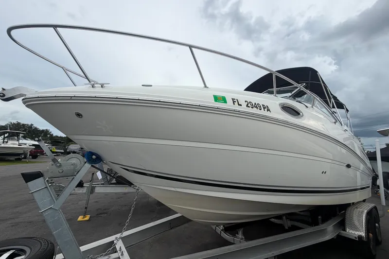 Slide: The Image of 2009 Sea Ray 240 Sundancer boat on trailer, overcast sky background. - 6
