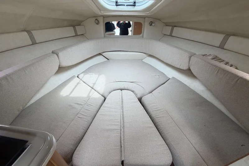 Slide: The Image of Interior cabin of 2009 Sea Ray 240 Sundancer with beige upholstery and overhead hatch. - 69