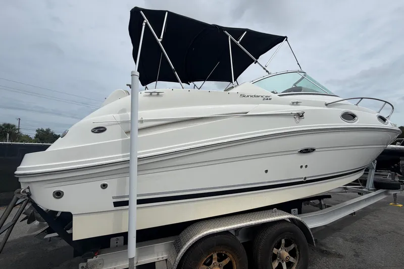 Slide: The Image of 2009 Sea Ray 240 Sundancer boat on trailer with black canopy, side view. - 3