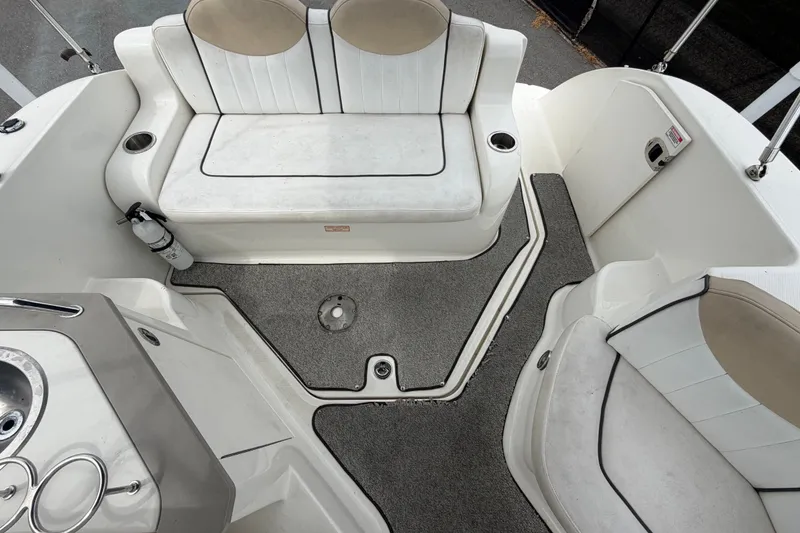 Slide: The Image of 2009 Sea Ray 240 Sundancer boat interior with seating and carpeted floor. - 90