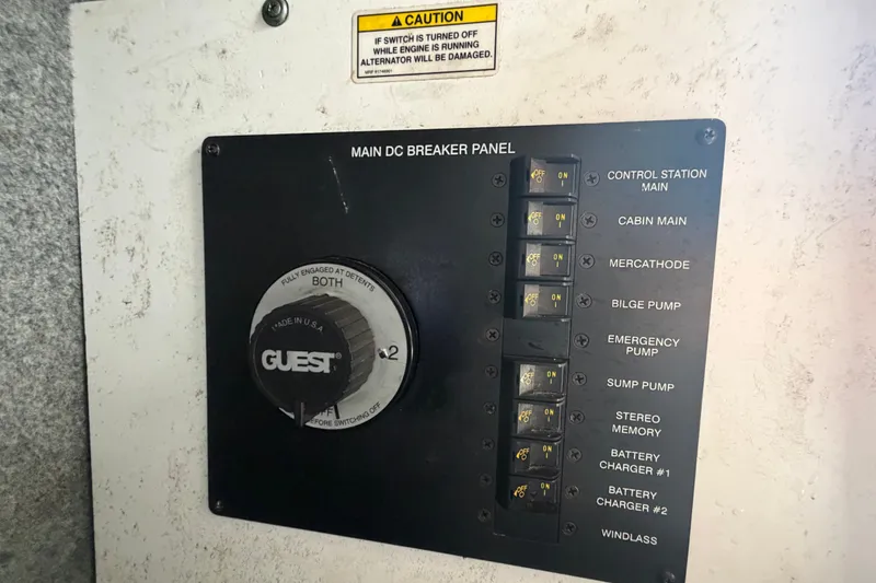 Slide: The Image of Main DC breaker panel on 2009 Sea Ray 240 Sundancer boat, featuring various switches and controls. - 24