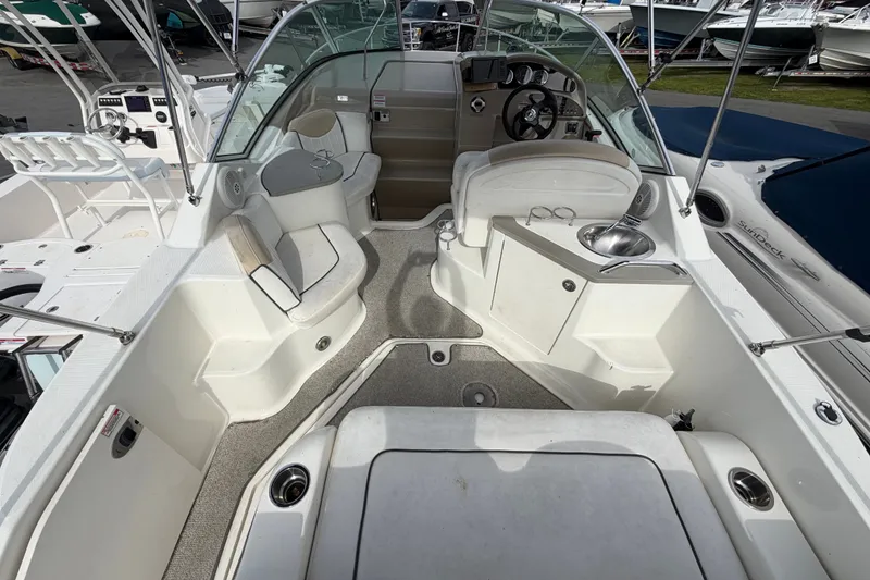 Slide: The Image of 2009 Sea Ray 240 Sundancer boat interior with seating and helm. - 11