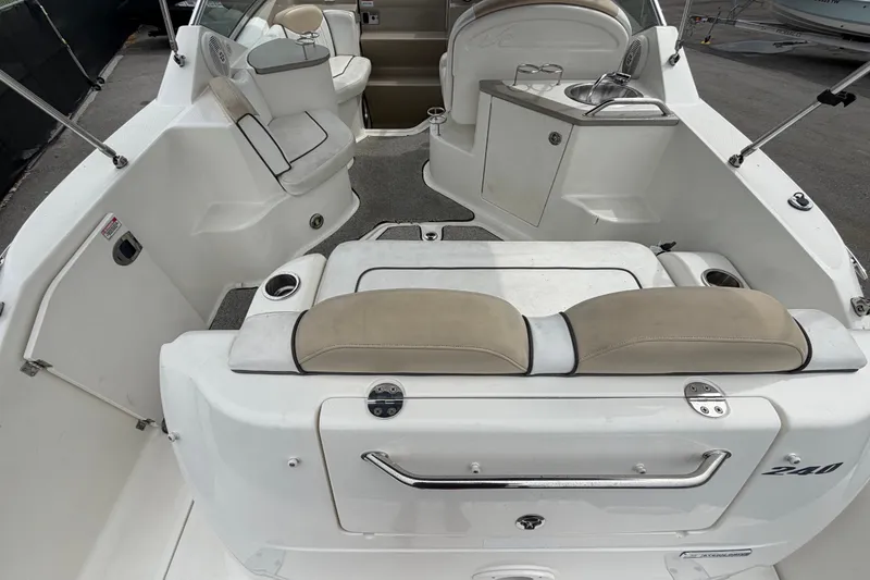 Slide: The Image of 2009 Sea Ray 240 Sundancer boat interior with seating and sink area. - 15