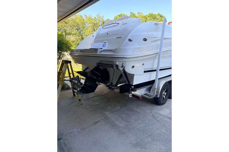 Slide: The Image of A 2009 Sea Ray 240 Sundancer on a trailer. The engine is visible. - 4
