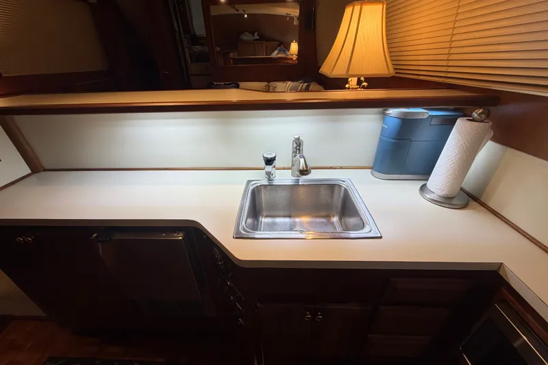 Slide: The Image of Kitchen area of a 1986 Viking 48 Motor Yacht with sink and countertop. - 17