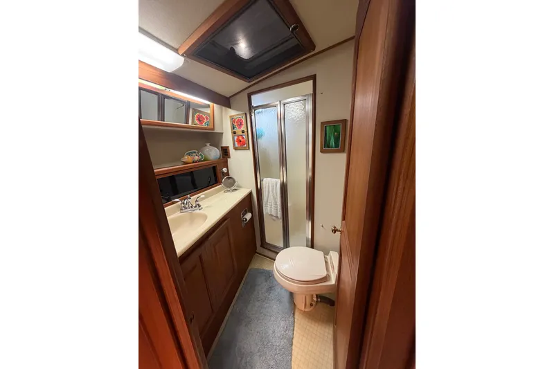 Slide: The Image of Bathroom interior of 1986 Viking 48 Motor Yacht with shower and wooden cabinetry. - 35
