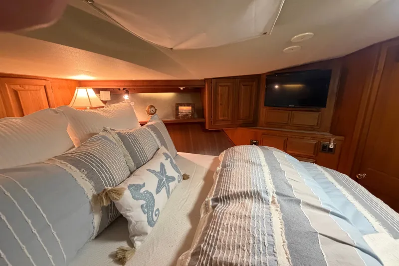 Slide: The Image of Cozy bedroom interior of 1986 Viking 48 Motor Yacht with nautical-themed bedding. - 39
