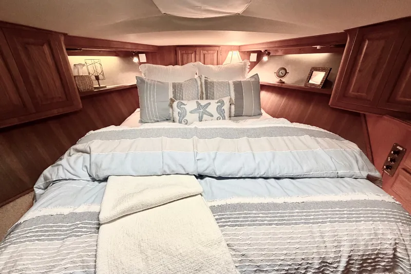 Slide: The Image of Cozy bedroom interior of 1986 Viking 48 Motor Yacht with nautical-themed bedding. - 41