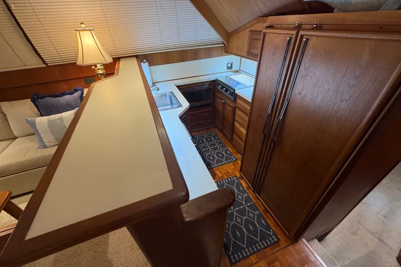 Slide: The Image of Interior of 1986 Viking 48 Motor Yacht with kitchen and seating area. - 14