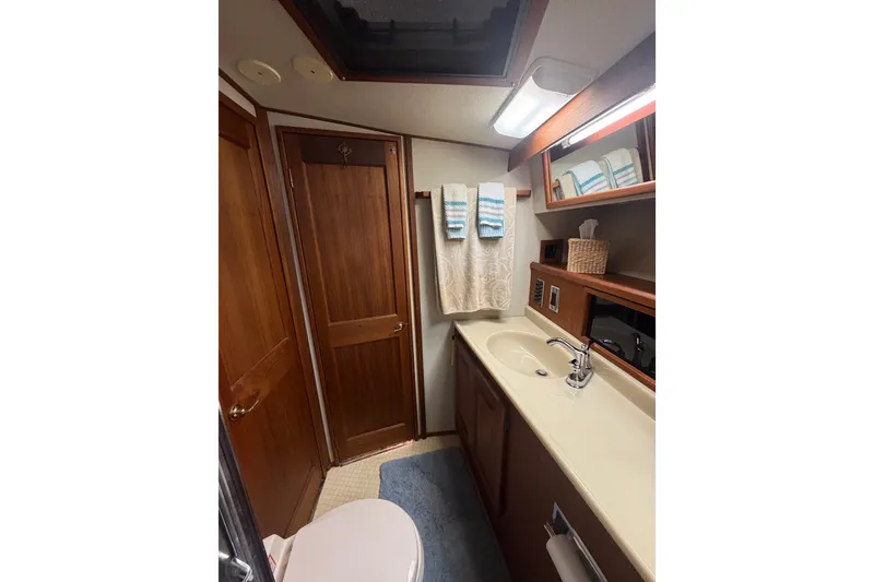 Slide: The Image of Bathroom interior of 1986 Viking 48 Motor Yacht with wooden cabinetry and modern fixtures. - 34